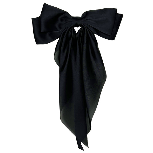 Flat lay photo of our Black Satin Hairbow hair clip on white background